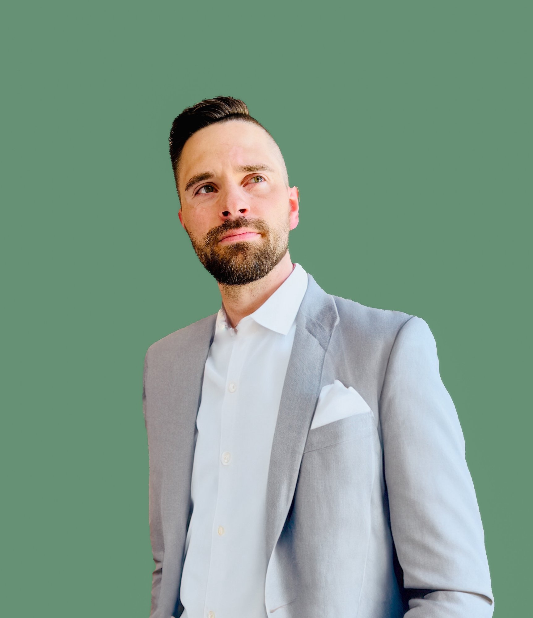 Handsome middle aged man with a bear and clean hair cut with gray suit on.